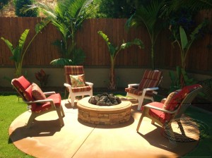 A fire pit by TRU Landscape Services with chairs
